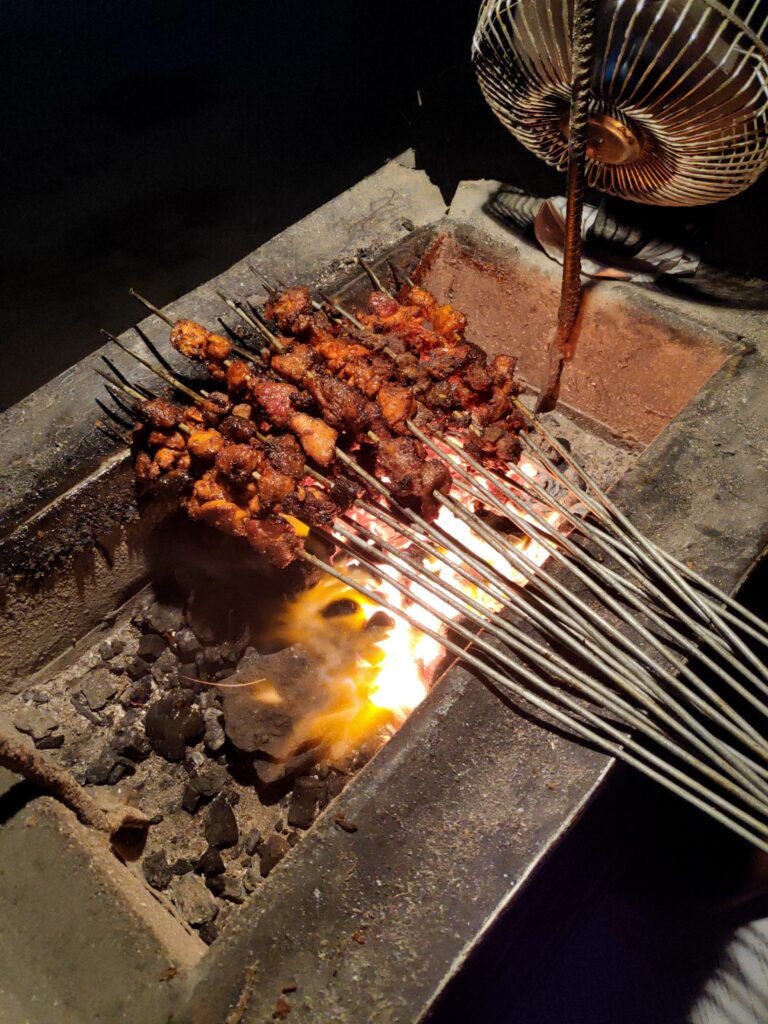 10 Must-Try Nepali Foods (with Culture & Origins), Grilled sekuwa meat skewers served on a wooden platter