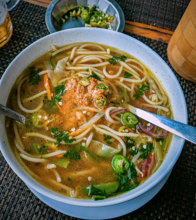Hot bowl of Nepali thukpa noodle soup served in a metal bowl, 10 Must-Try Nepali Foods (with Culture & Origins), Nepali food, Nepal travel tips, what to eat in Nepal, Nepal food, foodie in Nepal, saru's postcards