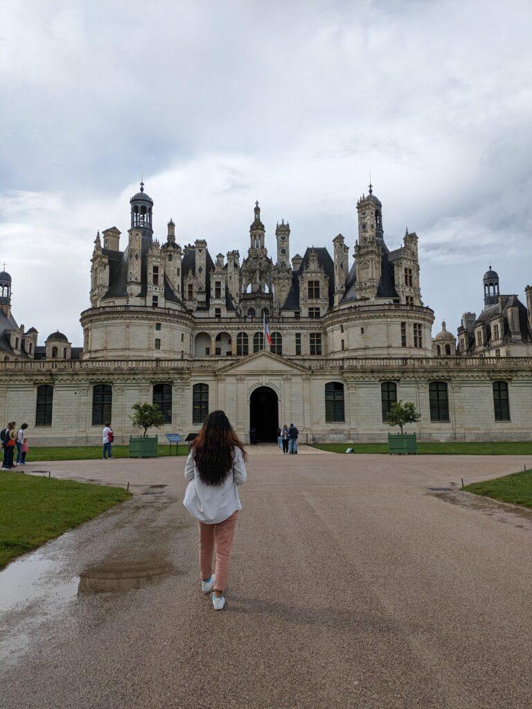 A Day at Château de Chambord: The Crown Jewel of the Loire Valley, Château de Chambord aerial view Loire Valley largest castle, Chambord Castle double helix staircase designed by Leonardo da Vinci, Château de Chambord façade with Renaissance and medieval architecture, Chambord Castle rooftop terraces with chimneys and spires, Château de Chambord grand entrance courtyard with visitors, Interior of Chambord Castle ornate ceiling and stone carvings, Château de Chambord reflected in moat at sunrise, Chambord Castle hunting lodge history exhibition room, Château de Chambord gardens and surrounding forest, Night view of Chambord Castle illuminated against dark sky
