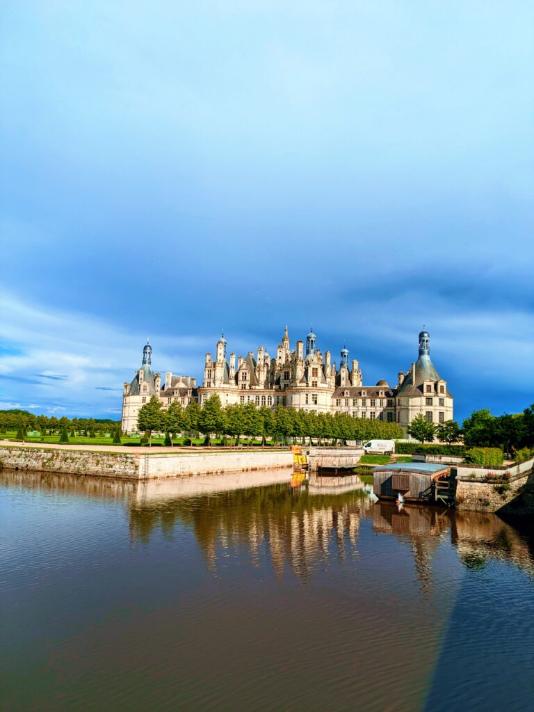 A Day at Château de Chambord: The Crown Jewel of the Loire Valley, Château de Chambord aerial view Loire Valley largest castle, Chambord Castle double helix staircase designed by Leonardo da Vinci, Château de Chambord façade with Renaissance and medieval architecture, Chambord Castle rooftop terraces with chimneys and spires, Château de Chambord grand entrance courtyard with visitors, Interior of Chambord Castle ornate ceiling and stone carvings, Château de Chambord reflected in moat at sunrise, Chambord Castle hunting lodge history exhibition room, Château de Chambord gardens and surrounding forest, Night view of Chambord Castle illuminated against dark sky