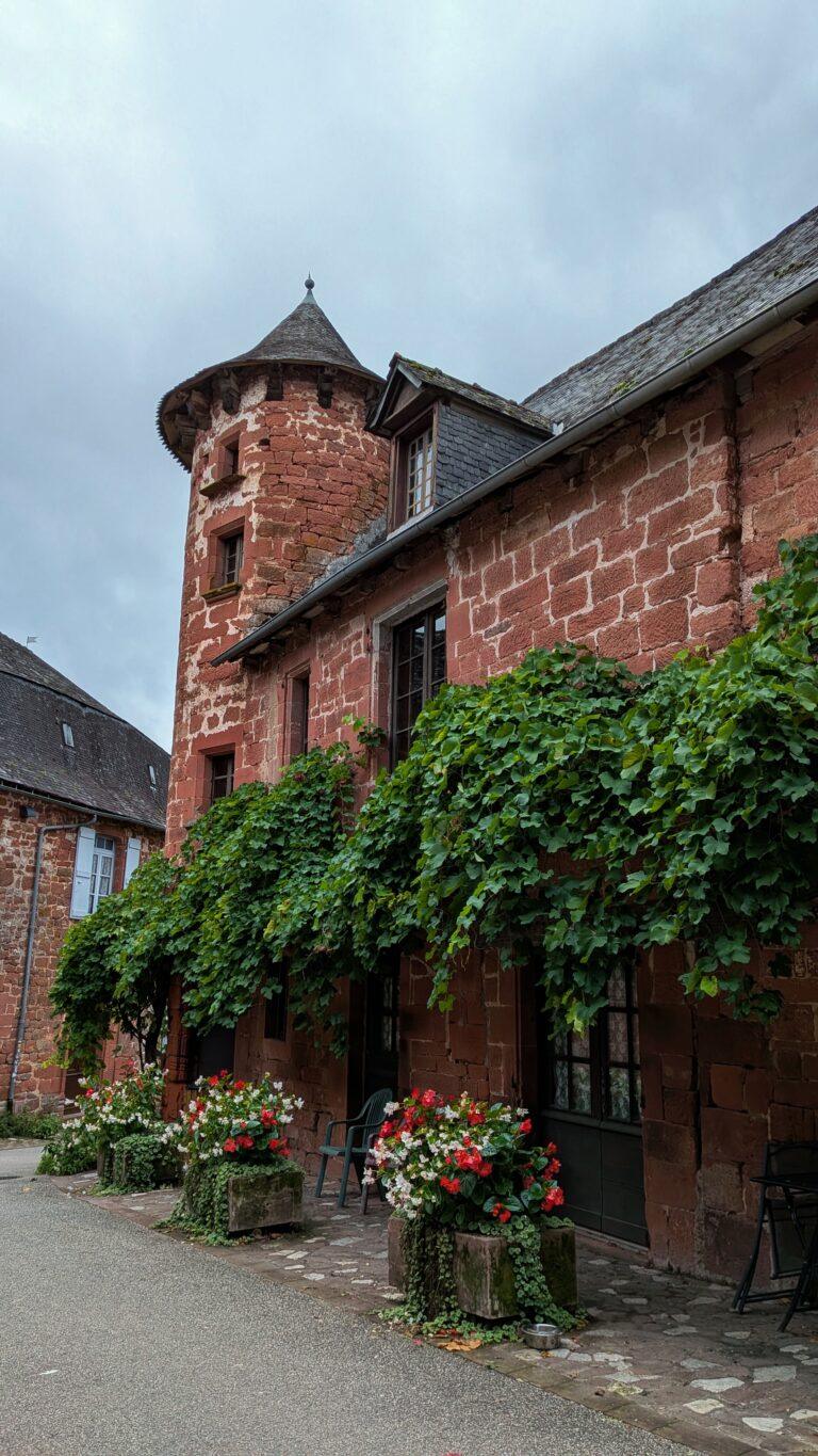 Collonges-la-Rouge village, red sandstone houses, medieval architecture, Limousin France Collonges-la-Rouge street view, cobblestone alley, ivy-covered houses, Corrèze village