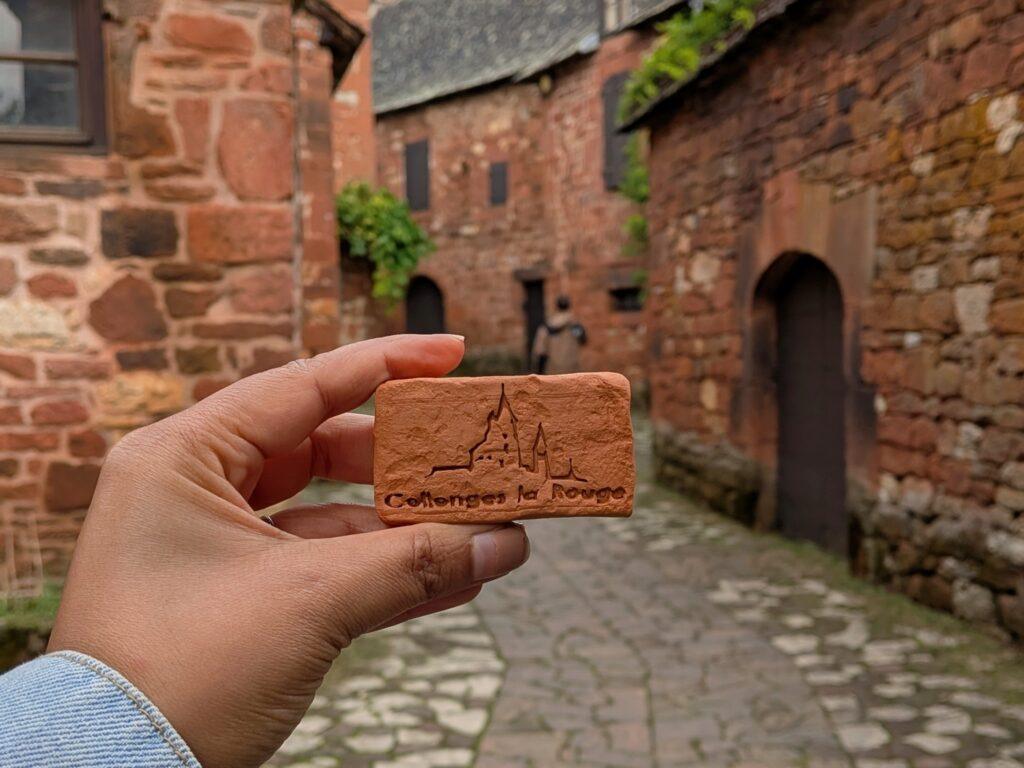 Collonges-la-Rouge: The Red Stone Gem of France, Collonges-la-Rouge village, red sandstone houses, medieval architecture, Limousin France, Collonges-la-Rouge alley, red stone walls, flowered balconies, charming street, saru's postcards, beautiful villages of France