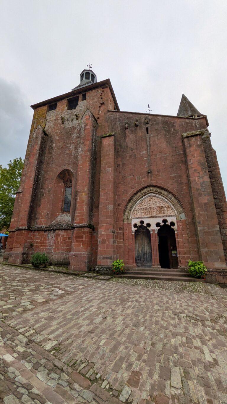 Saint-Pierre church, Collonges-la-Rouge, Romanesque architecture, octagonal bell tower,Collonges-la-Rouge: The Red Stone Gem of France, Collonges-la-Rouge village, red sandstone houses, medieval architecture, Limousin France, Collonges-la-Rouge alley, red stone walls, flowered balconies, charming street, saru's postcards, beautiful villages of France