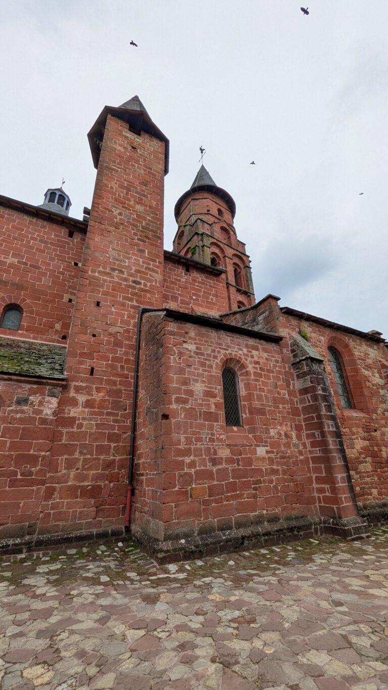 Saint-Pierre church, Collonges-la-Rouge, Romanesque architecture, octagonal bell tower,Collonges-la-Rouge: The Red Stone Gem of France, Collonges-la-Rouge village, red sandstone houses, medieval architecture, Limousin France, Collonges-la-Rouge alley, red stone walls, flowered balconies, charming street, saru's postcards, beautiful villages of France