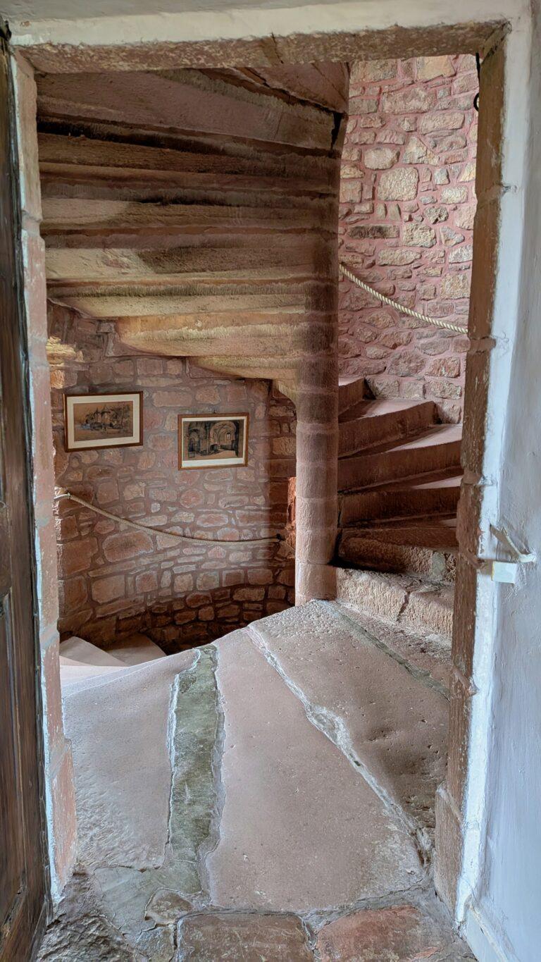 Collonges-la-Rouge castle, medieval tower, village fortifications, red stone skyline village castle ruins, Collonges-la-Rouge, panoramic view, historic site, Collonges-la-Rouge: The Red Stone Gem of France, Collonges-la-Rouge village, red sandstone houses, medieval architecture, Limousin France, Collonges-la-Rouge alley, red stone walls, flowered balconies, charming street, saru's postcards, beautiful villages of France