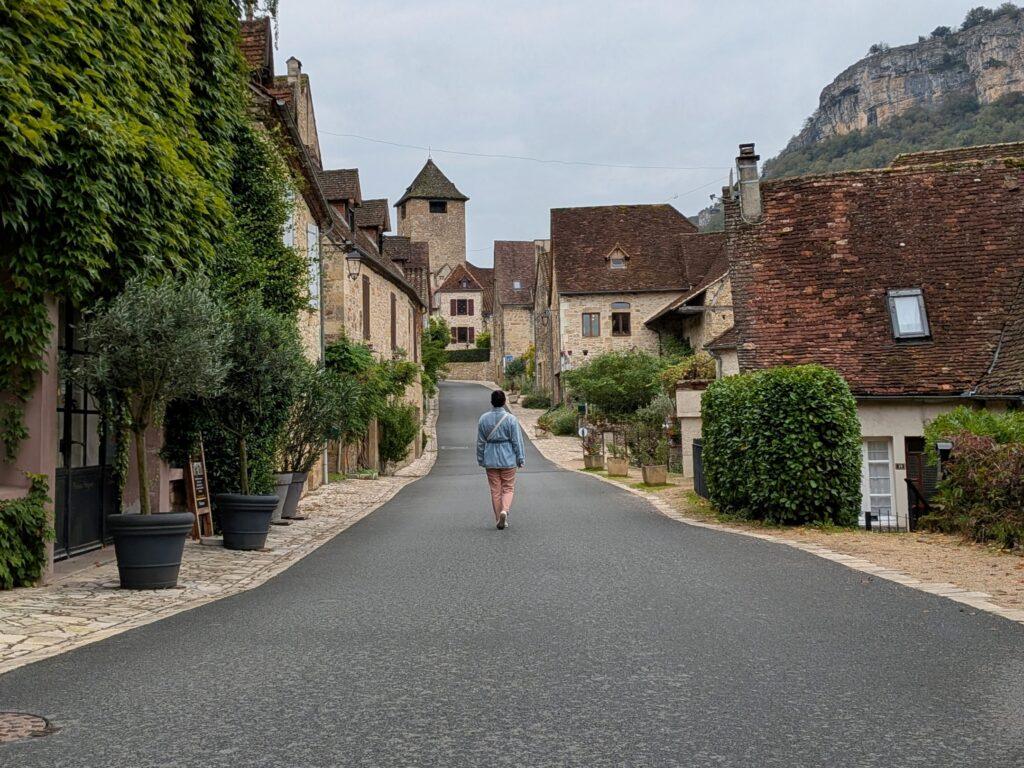 autoire village, golden stone houses, medieval architecture, lot region, france autoire valley, limestone cliffs, picturesque landscape, south west france autoire rooftops, panoramic view, charming french village, countryside scenery, saru's postcards, travel blog, cascade d'autoire, Autoire: The Little Versailles of the Lot