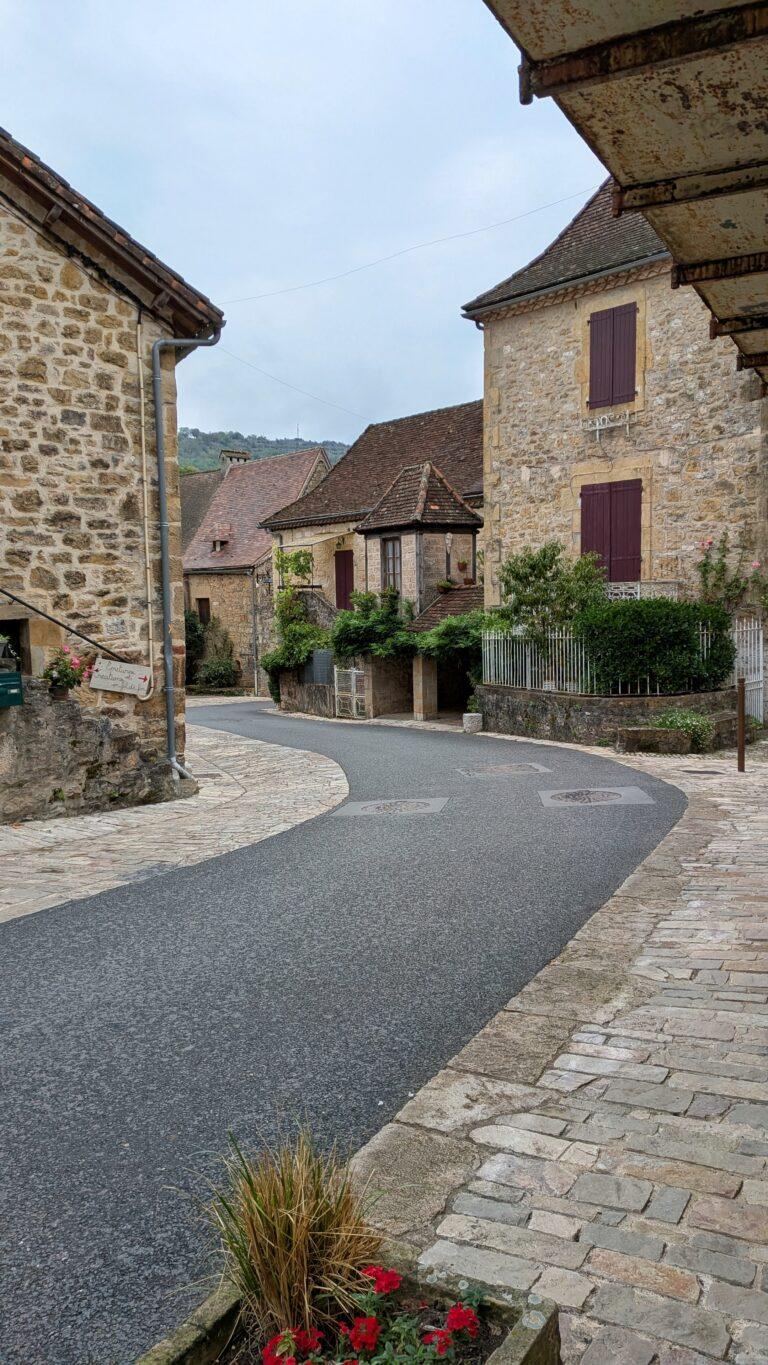 autoire village, golden stone houses, medieval architecture, lot region, france autoire valley, limestone cliffs, picturesque landscape, south west france autoire rooftops, panoramic view, charming french village, countryside scenery, saru's postcards, French village